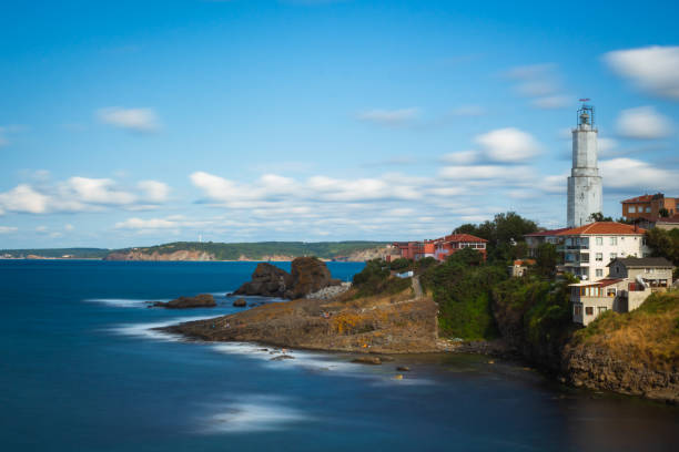 A fishing town with a lighthouse. Long exposure shot of a village near the sea.