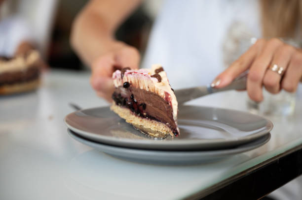 istock Placing a piece of delicious vegan chocolate cake on a plate 1291608607