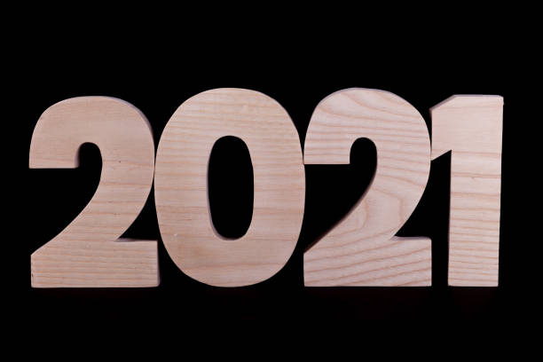 istock 2021 year wooden numbers joined on black 1291609754