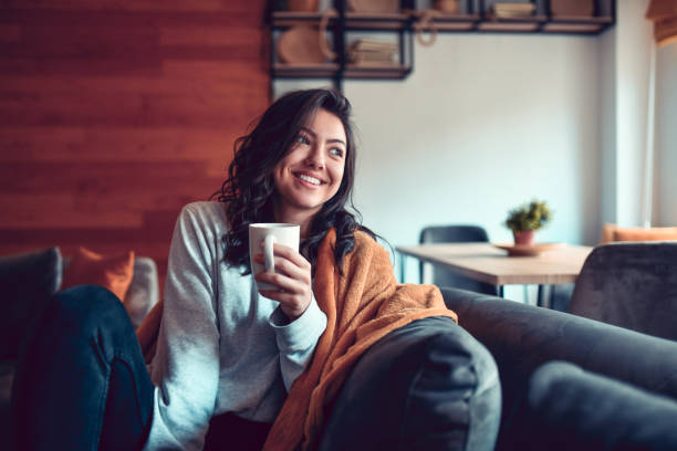 Smiling Female Drinking Coffee At Home