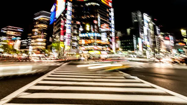 Blurred motion of cars, abstract motion blurry of big city. Ginza crossing at night, Tokyo, Japan