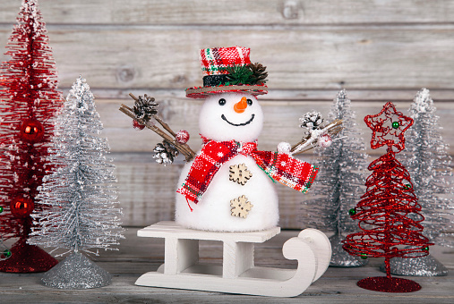 Christmas decorative snowman on white rustic wooden background. The font is free for commercial use.