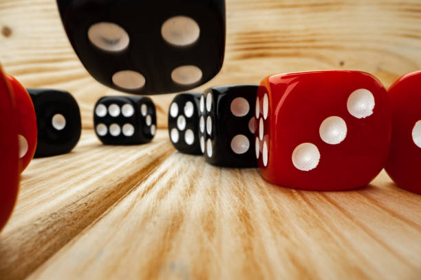 istock Red and black dice cubes on wooden background 1291618909