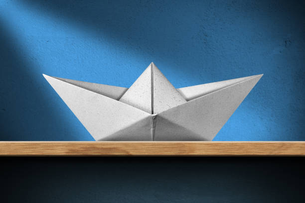 istock White paper boat on the shelf at home 1291619344