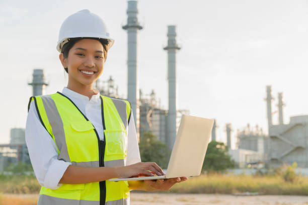 istock asian female engineer technician Industrial workers wearing safty uniform with walkie-talkie and laptop working inspection in a power plant background 1291620161