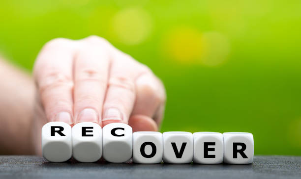 istock Hand turns dice and changes the word over to recover. 1291620227