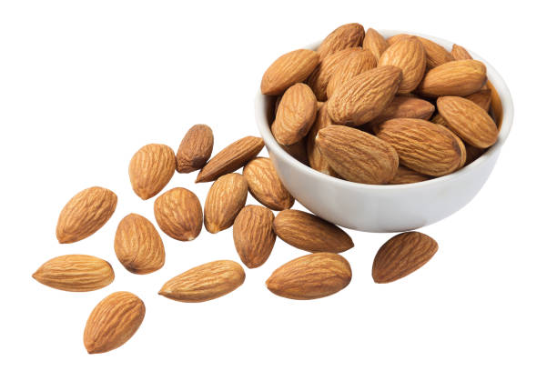 istock Raw almonds in a white cup isolated on white 1291621708