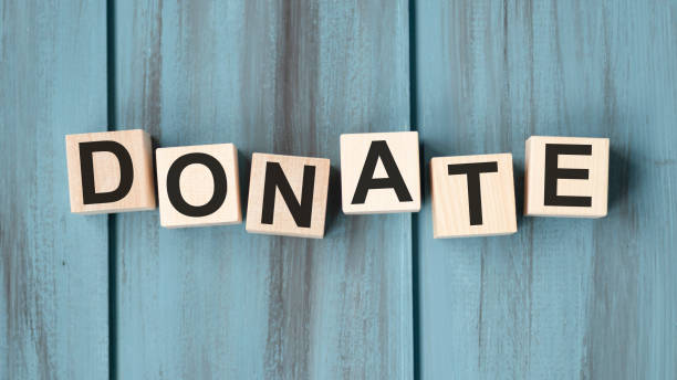 istock Donate text on a wooden blue background 1291621975
