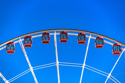 Ferris wheel against the blue sky close up