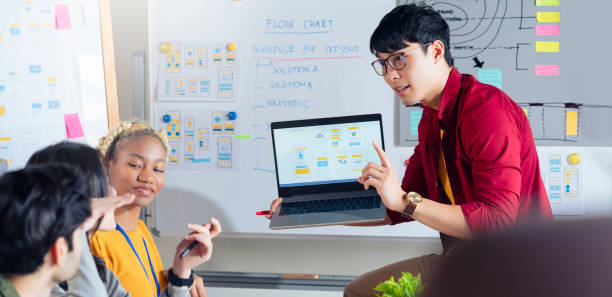 istock Meeting of UX developer and UI designer brainstorming about mobile app interface workflow design on table with coworker breif and color code at co-working space.Creative digital development agency. 1291623151