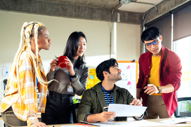 istock Meeting of UX developer and UI designer brainstorming about mobile app interface workflow design on table with coworker breif and color code at co-working space.Creative digital development agency. 1291623174