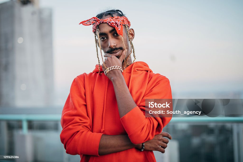 Portrait of one gangsta rapper outdoors in the city One African American man, young rapper, standing on the city street. Afroamerican underground style. Rap Stock Photo