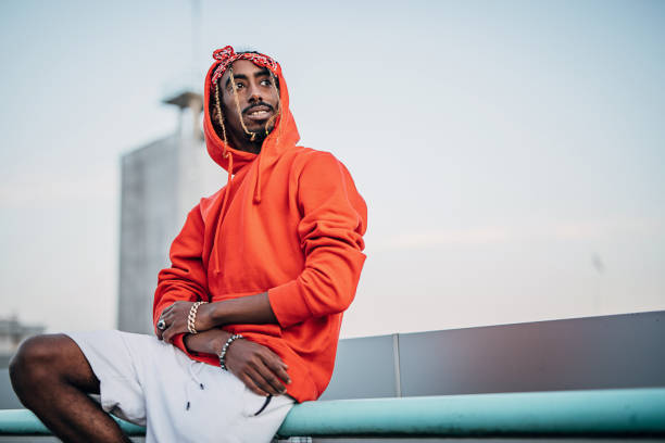 istock One young rapper sitting on a railing outdoors in the city. 1291624448