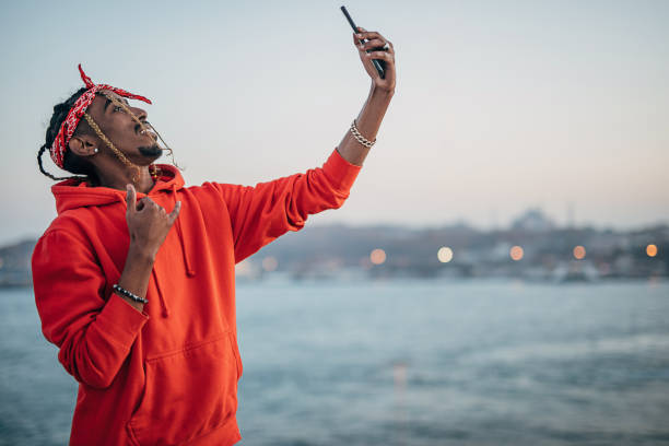 istock Young rapper making selfie with smart phone outdoors 1291624706