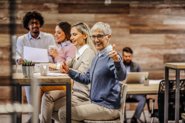 istock Modern business. Smiling colleagues having a coffee break. 1291625680