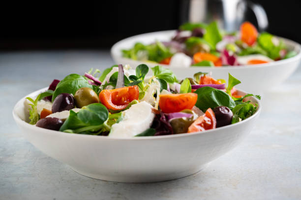 istock Fresh green salad with cherry tomato, mozzarella and olives. 1291626742