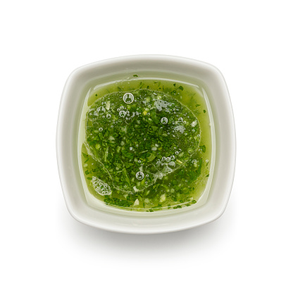 Basil pesto sauce in a jar. Ingredients for cooking, cheese, parmesan, garlic, olive oil.