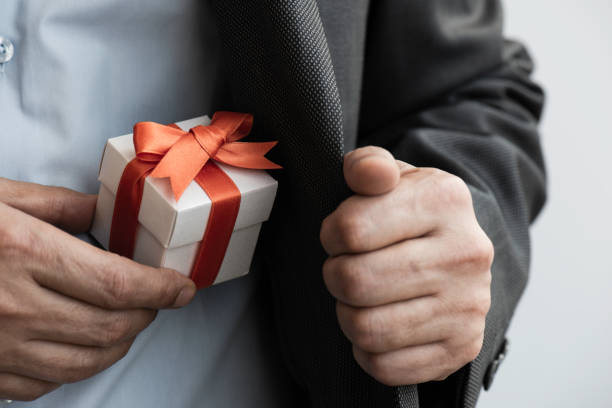 istock Businessman giving Gift Box 1291628110