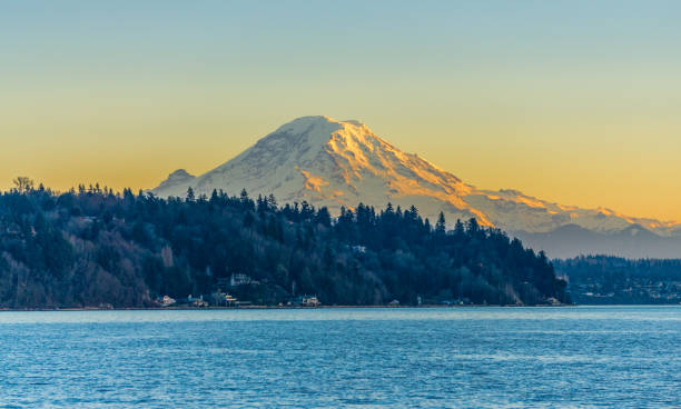 Twilight Mount Rainier 5 Mount Rainier across the Puget Sound at twilight. Photo taken from Burien, Washington. puget sound stock pictures, royalty-free photos & images