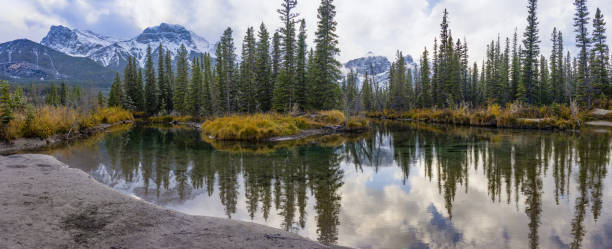 istock Snow capped Mount Lawrence Grassi mountain reflect on water surface in autumn. Beautiful natural scenery landscape 1291630057