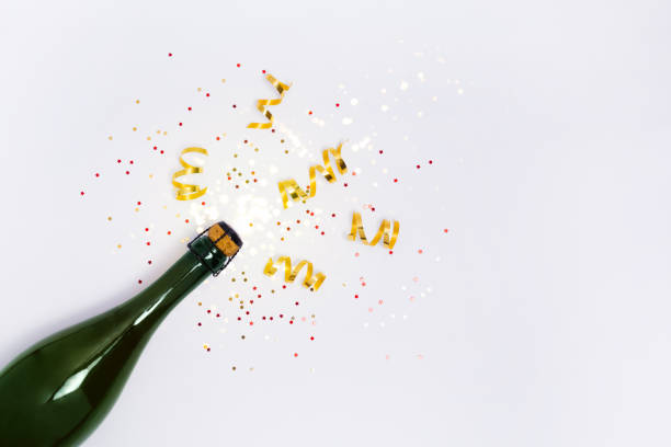 Several glass bottles of champagne with stoppers. Tube holding the wire. The background is blurred.