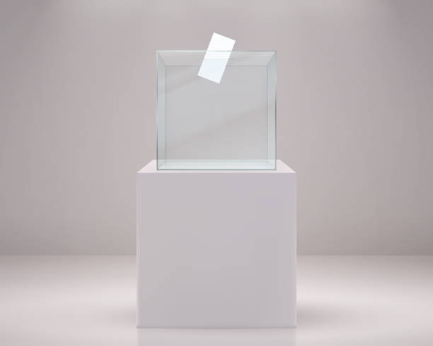 istock Realistic vote box. Election paper ballot, 3D transparent container on white podium. Plastic poll cube with hole and place for logo. Vector confidential choose political candidates 1291632838