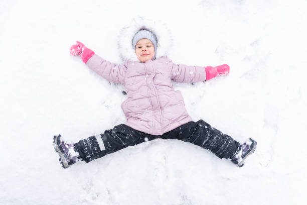 istock child plays with snow. winter activities 1291633030