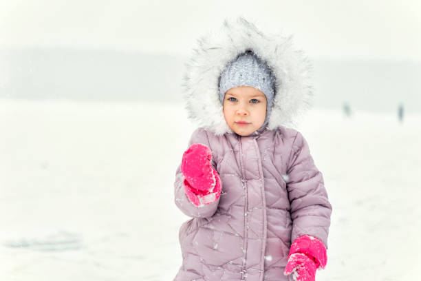 istock child plays with snow. winter activities 1291633038