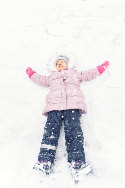 istock child plays with snow. winter activities 1291633039