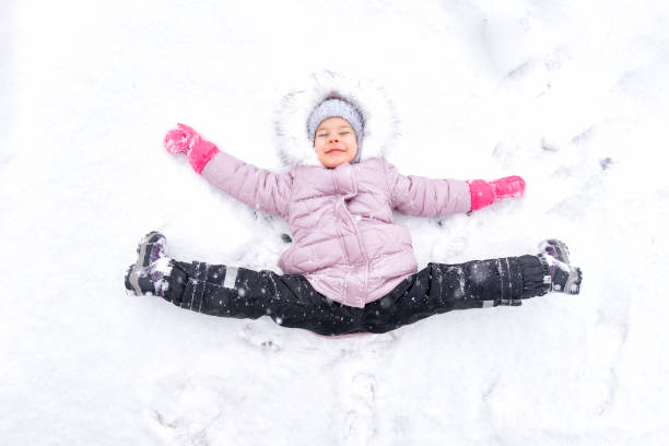 istock child plays with snow. winter activities 1291633040