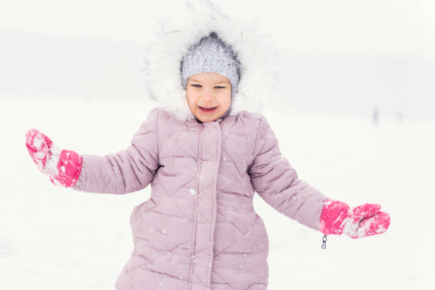 istock child plays with snow. winter activities 1291633049