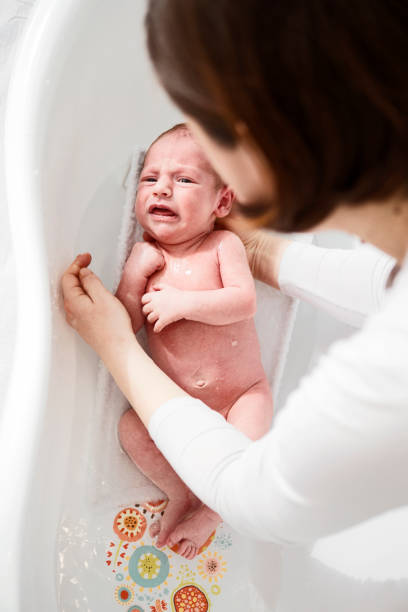 istock Wailing baby in bath tub 1291633148