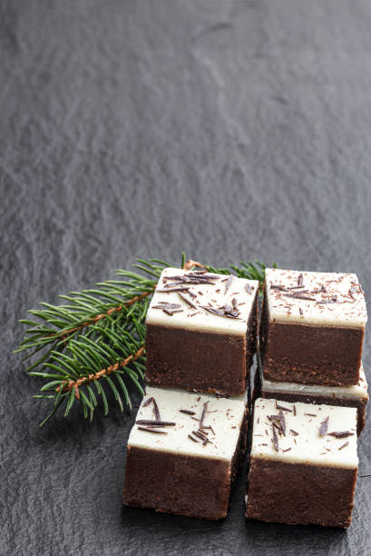 istock Chocolate brownie bites with sparklng chocolate topping on black stone background 1291633832
