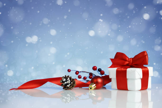 istock Christmas gift box with decorations on blue background 1291634067