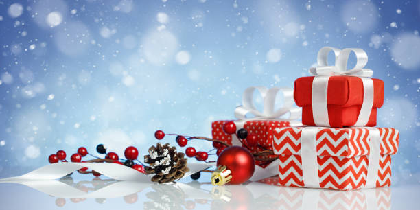 istock Christmas banner with three red gift boxes and decorations on blue background 1291634119
