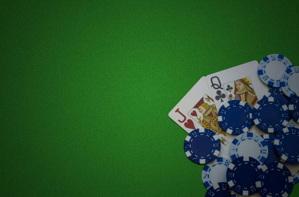 istock Poker cards and chips on green felt background 1291636468