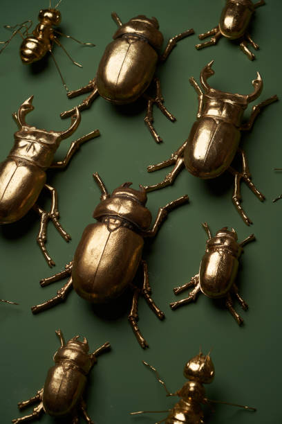 istock Golden insects on green background, top view 1291636488