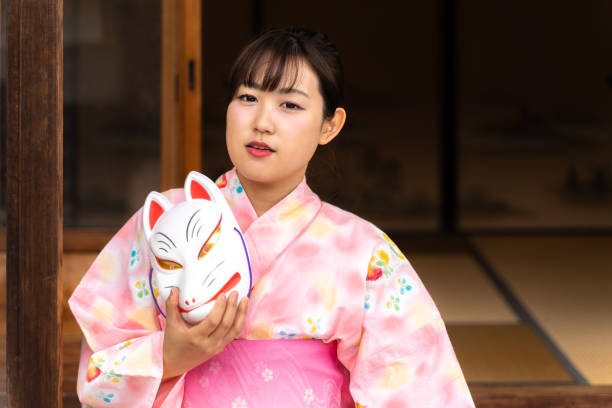 istock Woman in fox face and yukata 1291636997