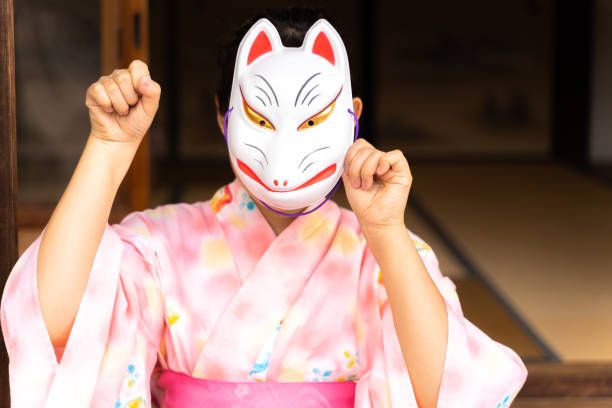 Woman in fox face and yukata