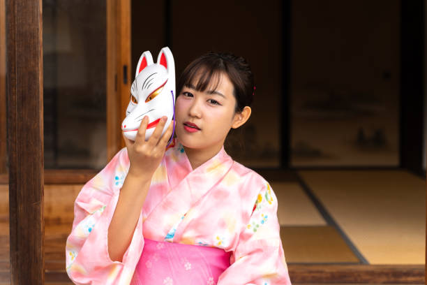 istock Woman in fox face and yukata 1291638016