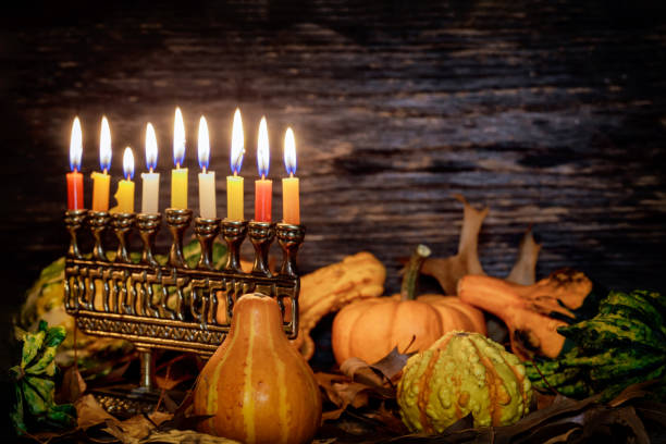 Chanukah holiday with decorate candles and pumpkin on wooden background Chanukah holiday with decorate candles and pumpkin on wooden desk background angolan kwanza photos stock pictures, royalty-free photos & images