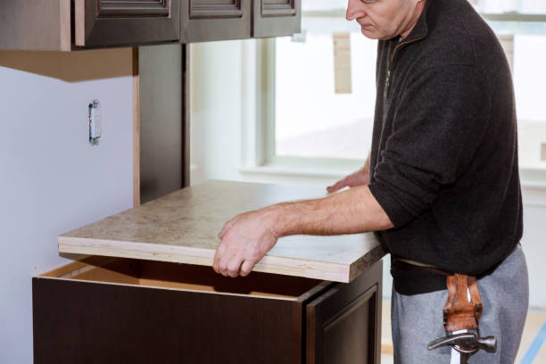 istock Installing contractors a laminate counter top a kitchen remodel. 1291638445