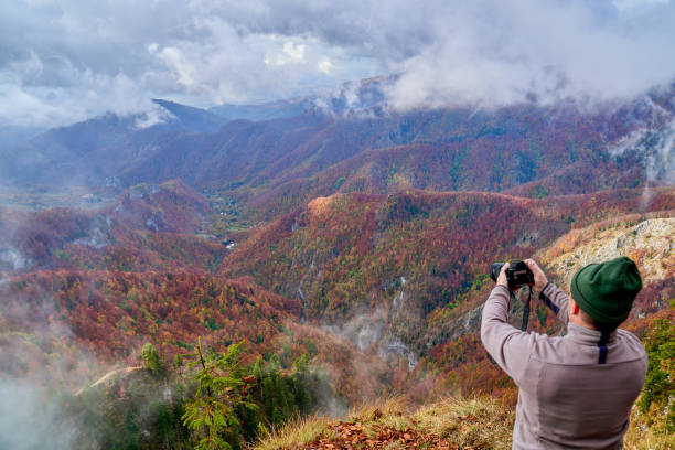 istock Professional nature photographer in the mountains 1291639780