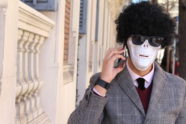 Funny businessman with skeleton face on the phone Funny businessman with skeleton face on the phone. skeleton waiting stock pictures, royalty-free photos & images
