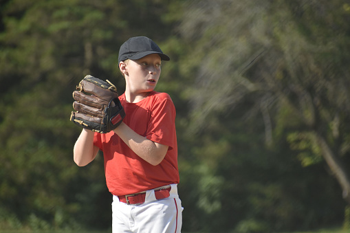 9 year old baseball pitcher concentrating on throwing, summer
Naperville, Illinois  USA