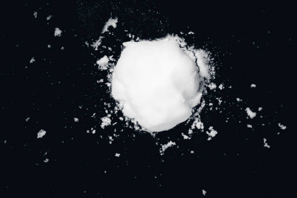 snowball splat on black wall snowball splat on black wall, close-up view snowball stock pictures, royalty-free photos & images