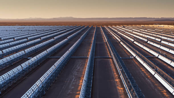 istock Low Drone Shot Looking Between Mirrors at Parabolic Trough Solar Plant 1291643732