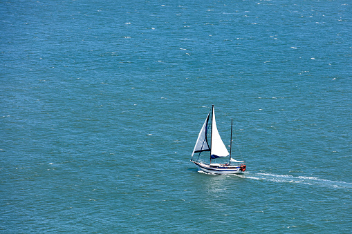 Yacht Sailing along the horizon on calm waters