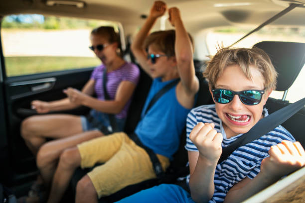 istock Happy kids travelling by car 1291647514