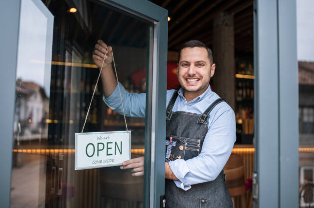 istock Happy entrepreneur opening his small business. 1291647628